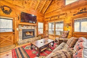 a living room with a couch and a fireplace at Sunrise Hideaway on Cherry Log Mountain in Blue Ridge
