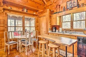 a kitchen with a table and chairs in a cabin at Sunrise Hideaway on Cherry Log Mountain in Blue Ridge
