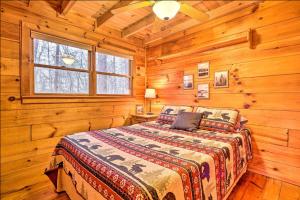 a bedroom with a bed in a log cabin at Sunrise Hideaway on Cherry Log Mountain in Blue Ridge