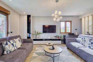 a living room with a couch and a table at Masanda in Ždrelac