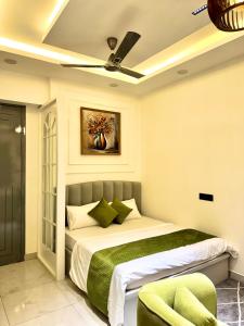a bedroom with a bed with a ceiling fan at Lux Lettings in Noida