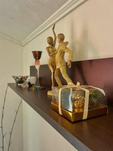 a shelf with a statue of two people on it at Apartments Lazarević in Kotor