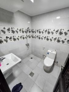 a bathroom with a toilet and a sink at Shahan Residence in Muscat