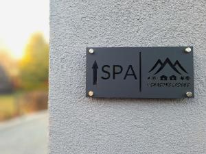 a sign on the side of a building at Domek A - domki w górach z prywatnym SPA - 4 seasons lodges Ustroń in Ustroń