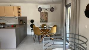 a kitchen and dining room with a table and chairs at Naiad Villa in Vari +47 photos