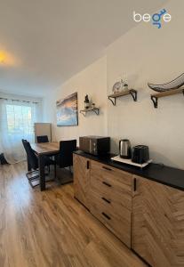 a kitchen with a wooden table and a dining room at BEGE APARTMENTS SmartLoft in Hof