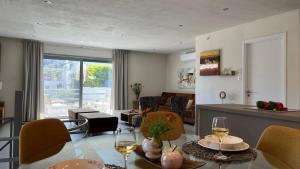 a kitchen and living room with a table and chairs at Naiad Villa in Vari
