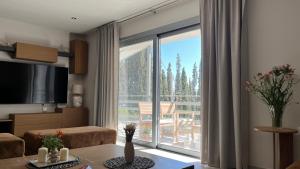a living room with a large window with a view at Naiad Villa in Vari