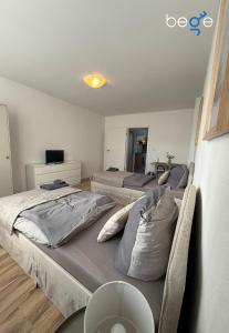 a bedroom with two beds and a table with a table at BEGE APARTMENTS SmartLoft in Hof