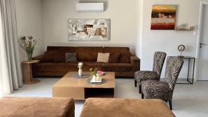 a living room with a couch and a coffee table at Naiad Villa in Vari