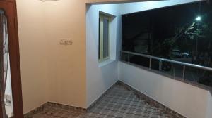 a room with a balcony with a large window at Bella Mi Casa Homestay in Chennai