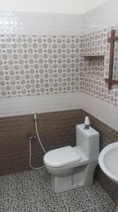 a bathroom with a toilet and a sink at Bella Mi Casa Homestay in Chennai