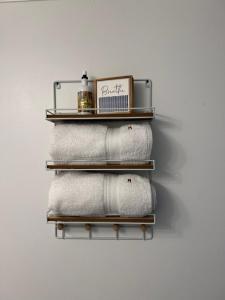 a towel rack with four towels on a wall at Lakeside Sunset - Hot Tub, Pool Table, Beautiful Views!! in Canyon Lake