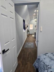 a hallway with a door leading to a bedroom at The Blue Goose in Marshall