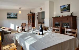 a table with a bottle of wine and glasses on it at Haus zum Ordenswald in Neustadt an der Weinstraße