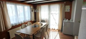 a dining room with a wooden table and chairs at Nebelmeer Chalet Grabs mit Panorama über das Rheintal in Grabs