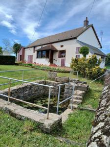 a house with stairs in front of a house at Gite les Tulipes in Liernais