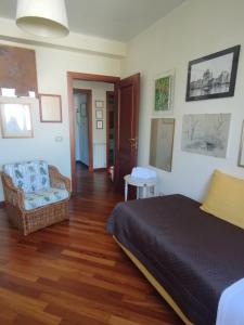 a bedroom with a bed and a chair in it at Villa Roverella Sutri Home Sweet Home Viterbo in Sutri
