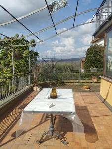 a white table on a patio with a glass roof at Villa Roverella Sutri Home Sweet Home Viterbo in Sutri