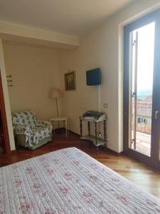a bedroom with a bed and a window with a view at Villa Roverella Sutri Home Sweet Home Viterbo in Sutri