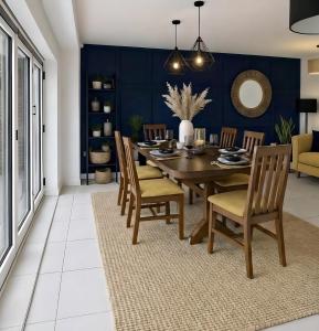a dining room with a wooden table and chairs at Your Versatile Luxury - Space for All- Sleeps 10 in Bedford