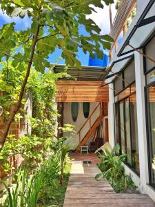 a porch of a house with a wooden walkway at Casa Isla - Private Retreat in Galapagos in Puerto Baquerizo Moreno