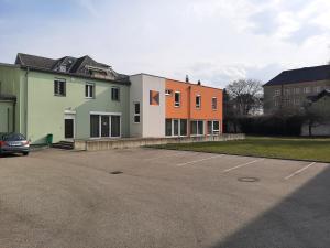 a car parked in a parking lot next to a building at Kolpinghaus Villach in Villach +8 photos