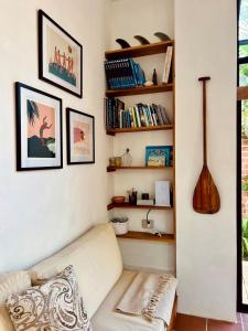 a living room with a couch and bookshelves at Casa Isla - Private Retreat in Galapagos in Puerto Baquerizo Moreno