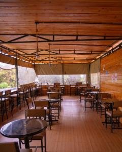 a dining room with tables and chairs in a tent at Njukiini Forest Lodge in Embu