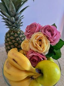 a bouquet of roses and bananas next to a pineapple at Apartments Lazarević in Kotor