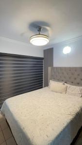 a bedroom with a large bed with a white comforter at The Urban Nest in Nelspruit