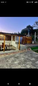 a patio with a bench and a table and a boat at Casa rustică in Ludoş