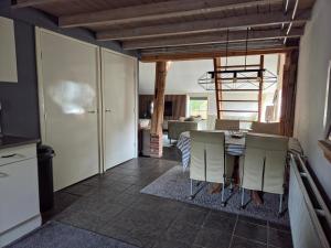 a kitchen and dining room with a table and chairs at Hoeve 1650 in Koekange +14 photos