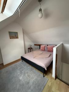 a bedroom with a bed in a attic at Homewood - entire property for 6 people - 4 adults maximum - in village 10 min from Disneyland Paris & TGV RER A in Montry