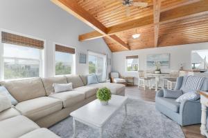 a living room with a couch and a table at 3218 - Swab The Duck in Duck +57 photos