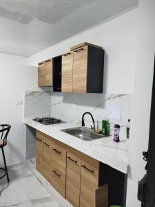 a kitchen with a sink and a stove at Santa Marta 1 in Yopal