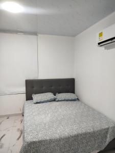 a bedroom with a bed with two pillows on it at Santa Marta 1 in Yopal