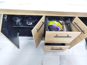 a kitchen cabinet with a drawer with pots and pans at Santa Marta 1 in Yopal