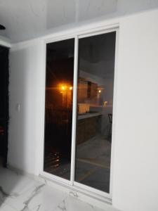 a window in a room with a view of the night at Santa Marta 1 in Yopal