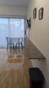 a dining room with a table and two chairs and a television at T1 curistes et vacances in Dax