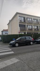 a black car parked in front of a building at T1 curistes et vacances in Dax