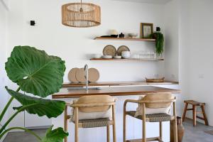 a kitchen with a counter with two chairs and a sink at Casa Abora - Ocean Views, Private Pool & Sunsets in La Pared