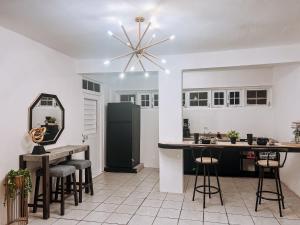 a kitchen with a black refrigerator and a table at Villa seda in Rincon