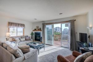 a living room with a couch and a fireplace at 4220 - Timeless in Duck