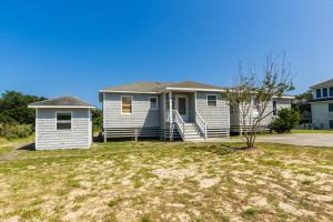 a blue house with a yard at 4601 - Sandy Bluff in Southern Shores