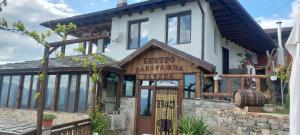 a house with a sign on the front of it at Панорамна гледка in Leshten +11 photos