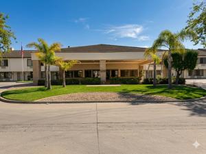 a house with palm trees in front of it at Inn of Lompoc in Lompoc