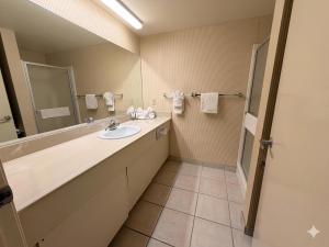 a bathroom with a sink and a mirror at Inn of Lompoc in Lompoc