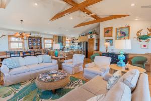 a living room with couches and a table at 5451 - Richardson in Nags Head