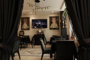 a dining room with black tables and chairs at Monun Boutique Hotel in Tirana